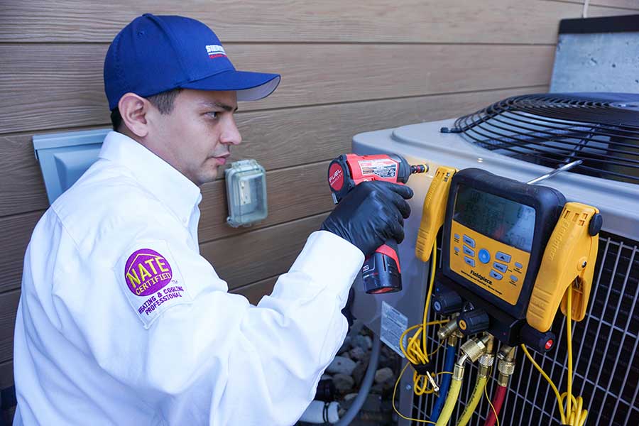 Professional HVAC technician servicing air conditioning unit
