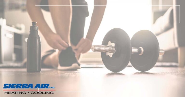 Image: A Woman Laces Up Her Shoes Before Working Out In Her Home Gym.