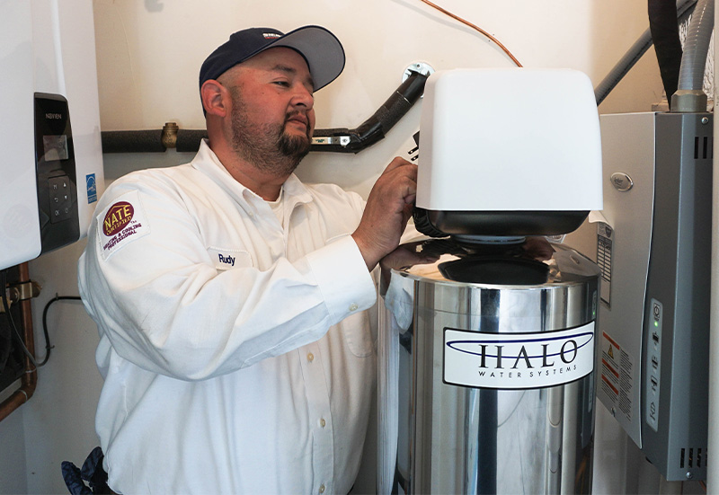 Tech with Water Purifier (2) Sierra Air technician installing a Halo whole-house water filtration system in Reno